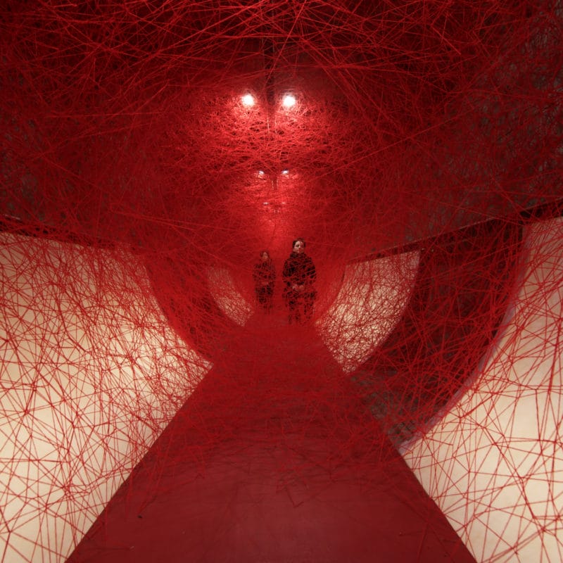 “Lifelines”, 2019, Performance/Installation: red wool, wooden chairs, Kulturprojekte Berlin, Germany, Photo Sunhi Mang, © SIAE, Rome, 2020 and the artist