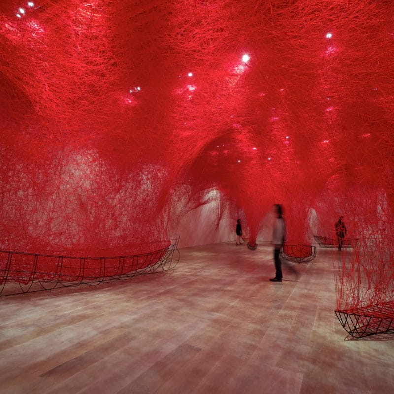 “Uncertain Journey”, 2019, metal frame, red wool, Installation view: Shiota Chiharu: The Soul, Trembles, Mori Art Museum, Tokyo, 2019, Photo by Sunhi Mang, Photo Courtesy: Mori Art Museum, Tokyo, © SIAE, Rome, 2020 and the artist