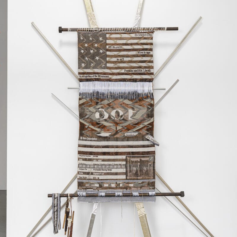 “In the Negative”, 2020, digital/hand-loomed fabric in cotton, wool, metallic, and linen yarns; t-shirt lashing; found framing and loom bars; pirns; brackets, 115” x 89” x 10”. Image courtesy of Shaun Roberts Photography, Kira Dominguez Hultgren