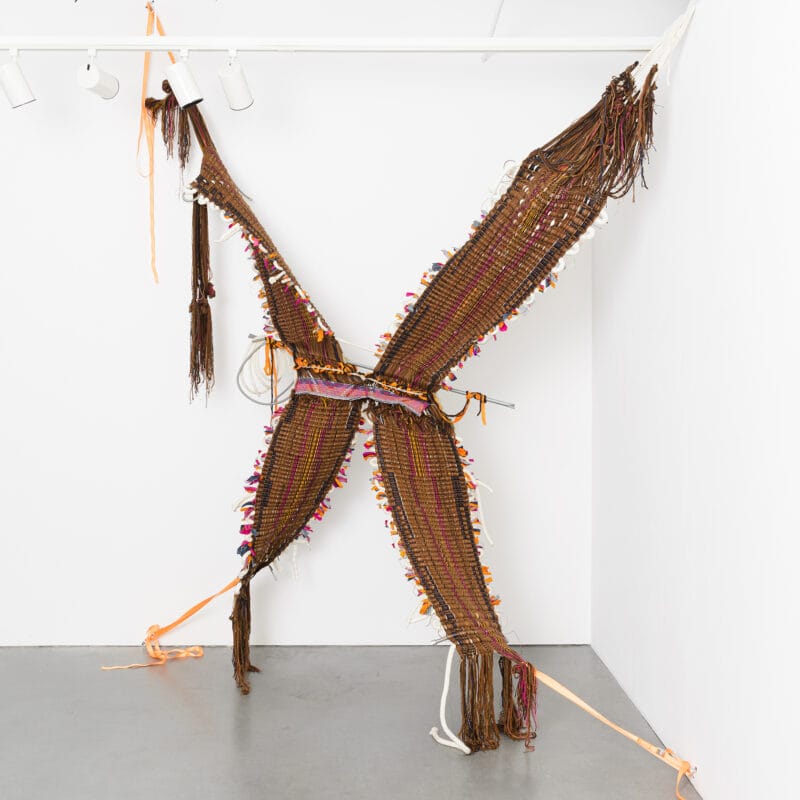 “Made in Mexico; XicanX and the Second(hand)-Generation”, 2020, handspun wool and other novelty yarns, used denim (made in Mexico), silk (made in India), gas and cotton pipelines, found bars and wire – stranded and single, straps. 139” x 72” x 96” (dimensions variable)
Image courtesy of Shaun Roberts Photography, copyright Kira Dominguez Hultgren