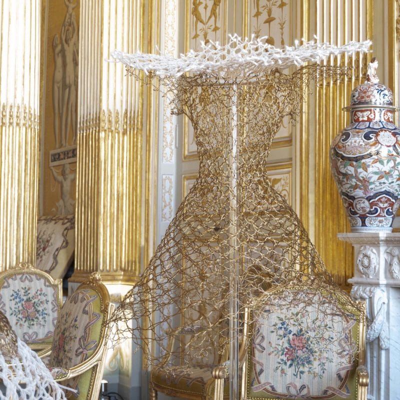 Photographer David Giancatarina -Robe au pois Valenciennes 1, bobbin lace made of brass, fishnet tubular design, plumes, 2012. Musée de la Dentelle et des Broderies de  Caudry collection