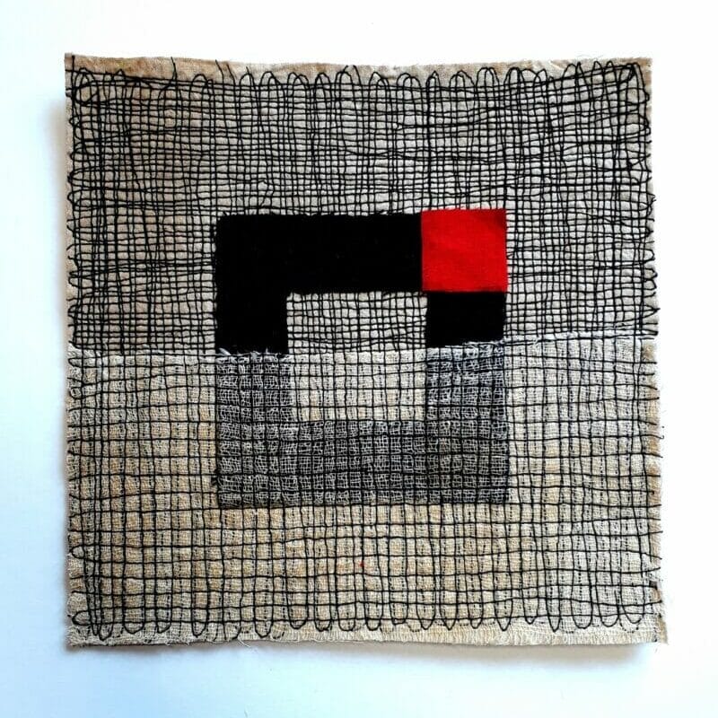 'Red square in open black square,' Machine stitched collage 2022, 8 inch sq.